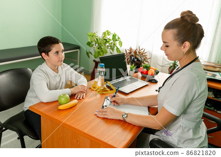 Female nutritionist doctor holding fresh fruits. Food choice, healthy 86821820