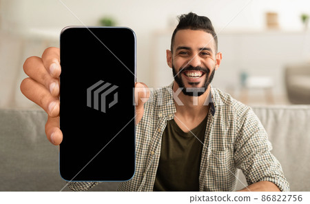 Happy arabic guy showing cell phone with empty screen 86822756