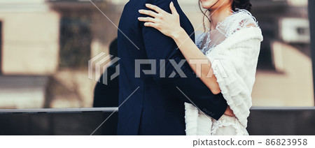 Groom hugs stunning bride Groom hugs stunning bride 86823958