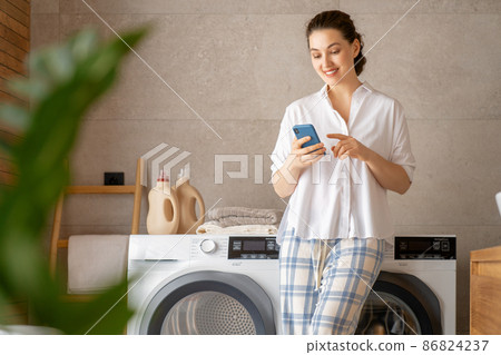 woman is doing laundry woman is doing laundry 86824237