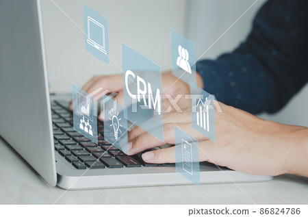 Hand typing on laptop concept. Icons CRM Customer Relationship Management business on virtual screen. Hand typing on laptop concept. Icons CRM Customer Relationship Management business on virtual screen. 86824786