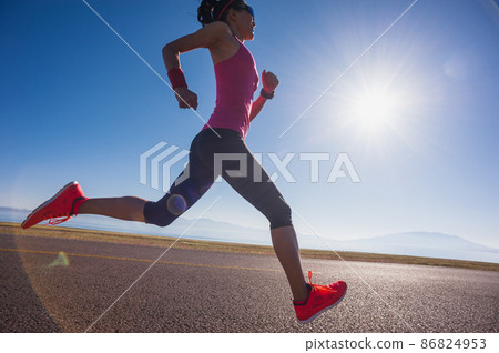 Healthy lifestyle young fitness woman runner running on sunrise road 86824953
