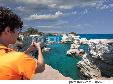 Melendugno, province of Lecce, Puglia, Italy. August 2021. The stacks of Sant'Andrea are an amazing naturalistic attraction Melendugno, province of Lecce, Puglia, Italy. August 2021. The stacks of Sant'Andrea are an amazing naturalistic attraction 86826387