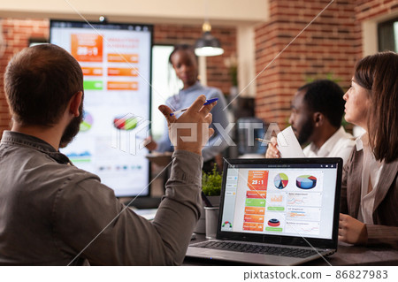 Businessman analyzing management statistics on laptop computer 86827983