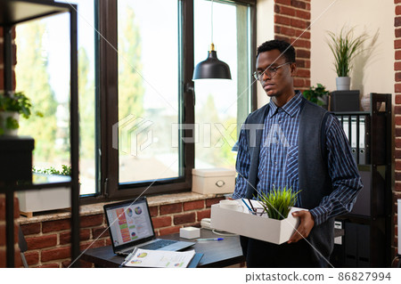 African american entrepreneur with glasses quitting his job having career problems 86827994