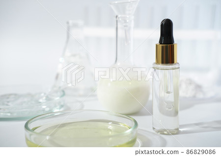 laboratory dishes and glassware on a lab table. fermentation, fermented beauty skin care. dropper bottle of solution or serum for anti age treatment. laboratory dishes and glassware on a lab table. fermentation, fermented beauty skin care. dropper bottle of solution or serum for anti age treatment. 86829086