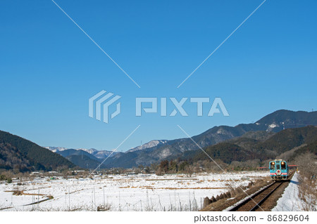 Tarumi Railway running in the snow field under clear skies Tarumi Railway running in the snow field under clear skies 86829604
