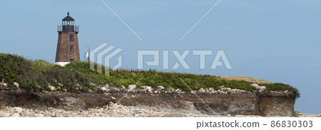 Point Judith Lighthouse above the sand rocks and snad dunes 86830303