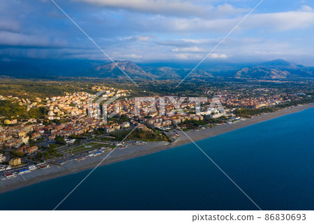 Aerial view of Scalea city and sea beach at sunset, province of Cosenza, Calabria region, Italy. Aerial view of Scalea city and sea beach at sunset, province of Cosenza, Calabria region, Italy. 86830693
