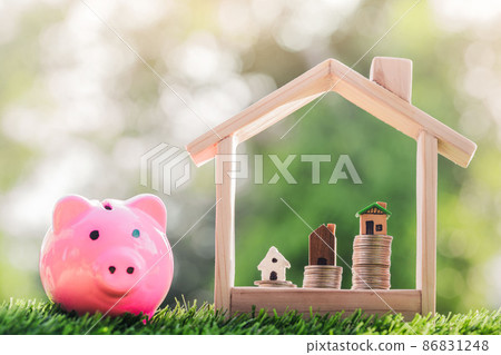 House on the coins placed in a model house and a Piggy bank on the grass. planning savings money of coins to buy a home 86831248