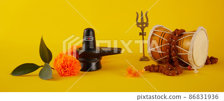 Happy Maha Shivaratri greeting card - Shiva Linga decorated with flowers, trishula, damru and bilva leaves. Hindu festival celebrated of Shiva Lord 86831936