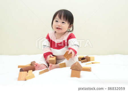 0 year old baby girl playing with blocks 86832059