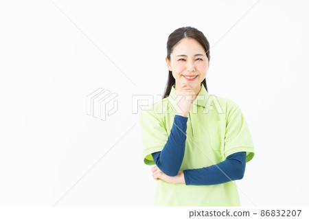Young woman of a certified care worker on a white background Young woman of a certified care worker on a white background 86832207