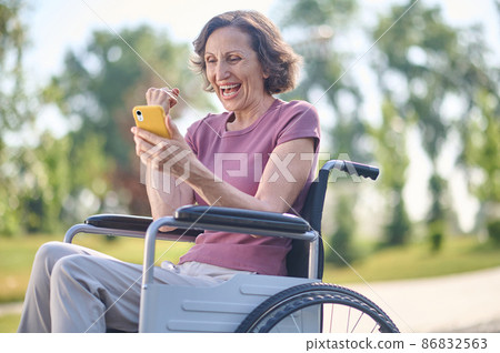 A woman on wheel-chair looking excited and feeling happy 86832563