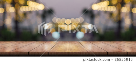 Empty wooden table top with lights bokeh on blur restaurant background. 86835913