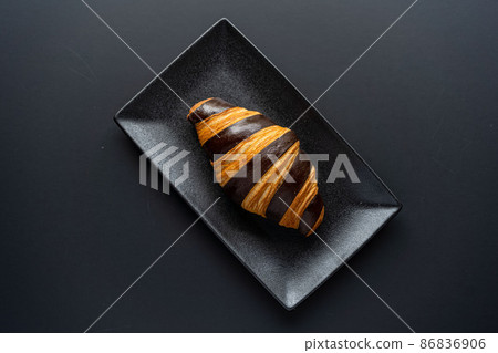 Croissant and a cup of tea on a neutral background selective focus Croissant and a cup of tea on a neutral background selective focus 86836906
