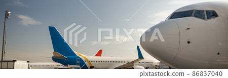 View of white airplane during refueling at airport outdoors on a daytime. Aircraft details 86837040