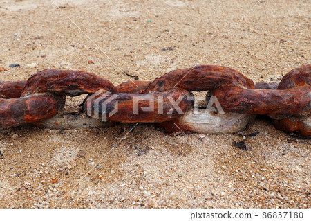 Old rusty chain on the beach sand Old rusty chain on the beach sand 86837180