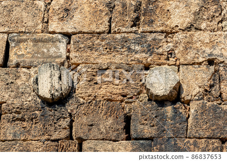 stonework of an ancient wall, antique columns are used among the bricks stonework of an ancient wall, antique columns are used among the bricks 86837653