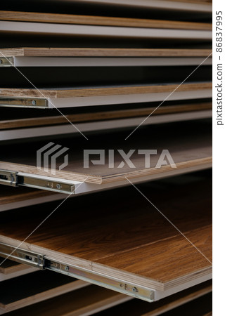 Laminate background. Samples of laminate or parquet with a pattern and wood texture for flooring and interior design. Production of wooden floors Laminate background. Samples of laminate or parquet with a pattern and wood texture for flooring and interior design. Production of wooden floors 86837995