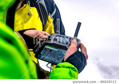 remote controller of an unmanned aerial vehicle in the hands of an operator in winter remote controller of an unmanned aerial vehicle in the hands of an operator in winter 86838513