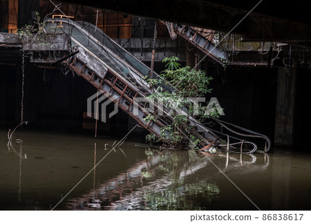 Damaged escalators and waterlogged in abandoned shopping mall building. Damaged escalators and waterlogged in abandoned shopping mall building. 86838617