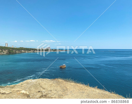 sea with blue, clean and salty water. a boat with tourists floats on the water. fishing in sea water. vacation at sea. yacht trip. seaside resort sea with blue, clean and salty water. a boat with tourists floats on the water. fishing in sea water. vacation at sea. yacht trip. seaside resort 86838868