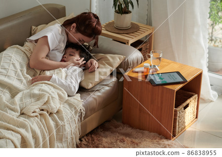 Mother Kissing Sick Son Mother Kissing Sick Son 86838955
