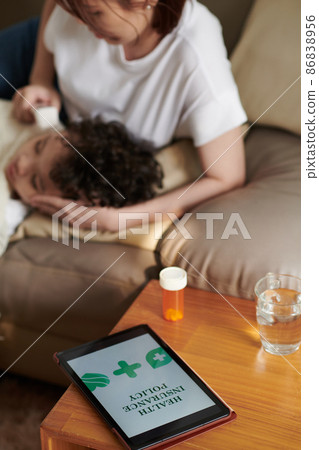 Health Insurance Policy on Tablet 86838956
