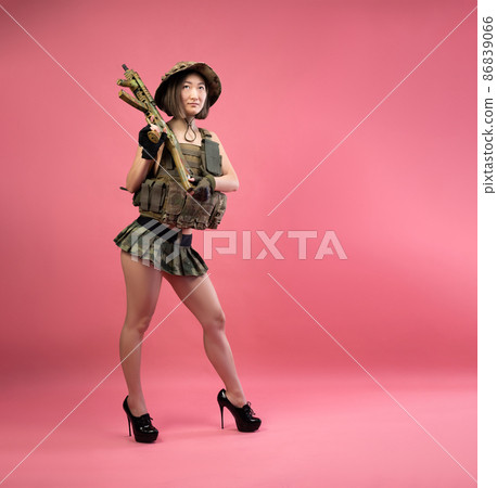 sexy Asian woman in military clothes with an automatic rifle in her hands while serving in the army 86839066
