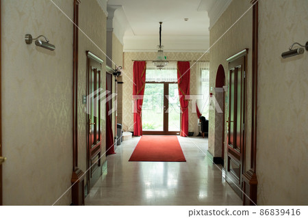 The hotel interior of the hallway leading to the outdoor terrace. The hotel interior of the hallway leading to the outdoor terrace. 86839416
