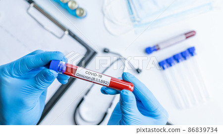 Omicron mutation coronavirus variant. Medical laboratory doctor holding test tube in hospital laboratory. Pandemic prevention. Clinical research. Omicron mutation coronavirus variant. Medical laboratory doctor holding test tube in hospital laboratory. Pandemic prevention. Clinical research. 86839734