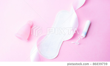 Menstrual pads, menstruation cup and tampon for woman hygiene on pink background. Menstruation feminine period. Flat lay banner, copy space for text. Gynecological care. 86839739