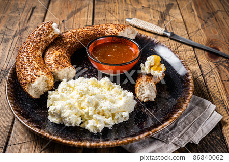 Tradirional Turkish breakfast - kaymak clotted cream, bagel simit and honey. Wooden background. Top view Tradirional Turkish breakfast - kaymak clotted cream, bagel simit and honey. Wooden background. Top view 86840062