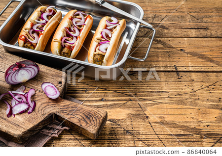 Vegan Vegetarian hot-dogs with onion and meatless sausage. Wooden background. Top view. Copy space Vegan Vegetarian hot-dogs with onion and meatless sausage. Wooden background. Top view. Copy space 86840064