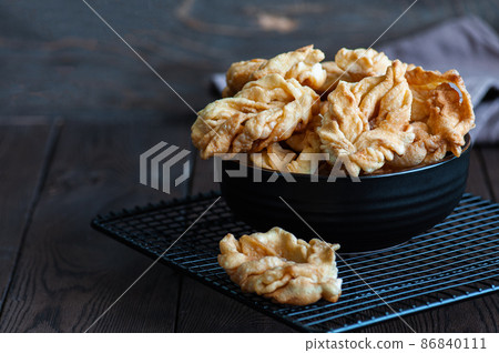 Angel wings, deep-fried sweet crisp pastry, close up. Festive food. Angel wings, deep-fried sweet crisp pastry, close up. Festive food. 86840111