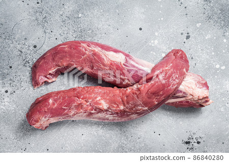 Raw pork tenderloin fillet meat. Gray background. Top view 86840280