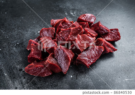 Raw sliced Beef or veal heart. Black background. Top View Raw sliced Beef or veal heart. Black background. Top View 86840530