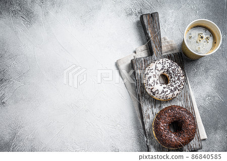 Fresh Chocolate artisan donuts and take away coffee. White background. Top view. Copy space Fresh Chocolate artisan donuts and take away coffee. White background. Top view. Copy space 86840585