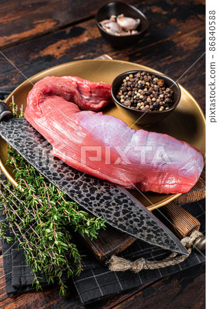 Raw beef veal tenderloin, fresh meat for fillet mignon steaks with herbs. Wooden background. Top view Raw beef veal tenderloin, fresh meat for fillet mignon steaks with herbs. Wooden background. Top view 86840588
