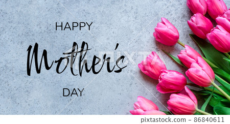 Mother's Day Concept. Fresh tulip flowers on a gray concrete background. Bright spring background. Mother's Day Concept. Fresh tulip flowers on a gray concrete background. Bright spring background. 86840611