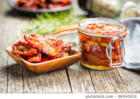 Sun dried tomatoe. Pickled tomatoes in jar. Sun dried tomatoe. Pickled tomatoes in jar. 86840816
