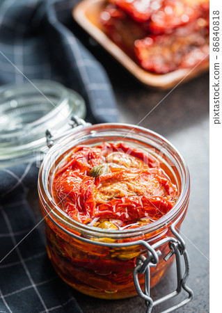 Sun dried tomatoe. Pickled tomatoes in jar. Sun dried tomatoe. Pickled tomatoes in jar. 86840818