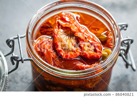 Sun dried tomatoe. Pickled tomatoes in jar. Sun dried tomatoe. Pickled tomatoes in jar. 86840821