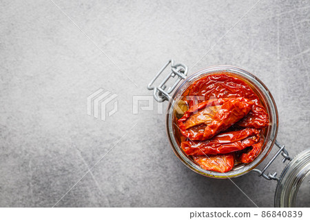 Sun dried tomatoe. Pickled tomatoes in jar on kitchen table. Sun dried tomatoe. Pickled tomatoes in jar on kitchen table. 86840839