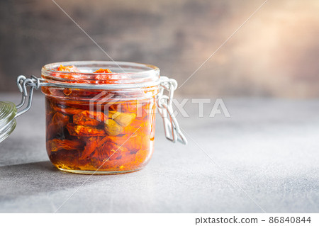 Sun dried tomatoe. Pickled tomatoes in jar. Sun dried tomatoe. Pickled tomatoes in jar. 86840844