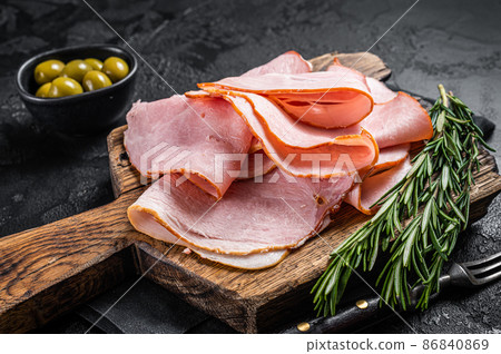 Pork ham slices on cutting board, Italian Prosciutto cotto. Black background. Top view Pork ham slices on cutting board, Italian Prosciutto cotto. Black background. Top view 86840869