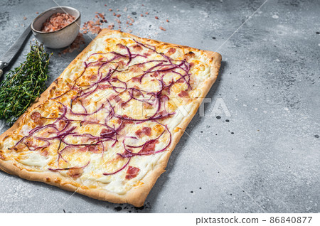 Traditional German Flammkuchen pie with ham and onion. Gray background. Top view. Copy space 86840877