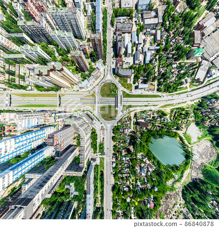 Aerial city view with crossroads and roads, houses, buildings, parks and parking lots. Sunny summer panoramic image Aerial city view with crossroads and roads, houses, buildings, parks and parking lots. Sunny summer panoramic image 86840878