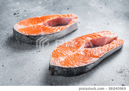 Fresh Raw Salmon Fish Steaks. Gray background. Top view Fresh Raw Salmon Fish Steaks. Gray background. Top view 86840969